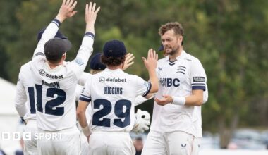 Middlesex players rush to congratulate Tom Helm on taking a Lancashire wicket