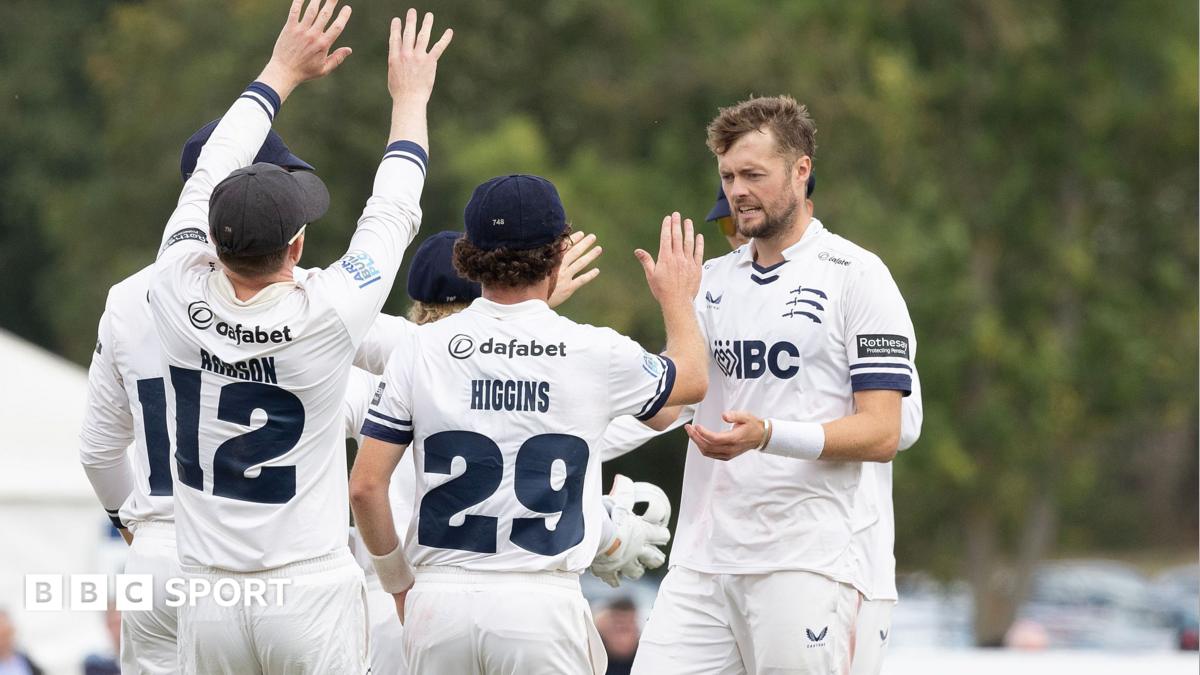 Middlesex players rush to congratulate Tom Helm on taking a Lancashire wicket
