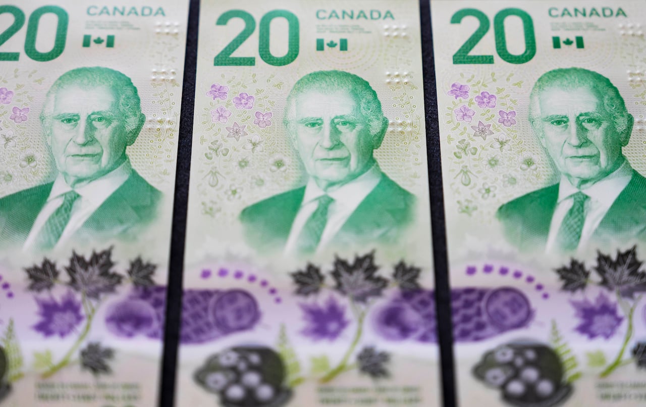 Three Canadian $20 bills with a picture of King Charles on them.