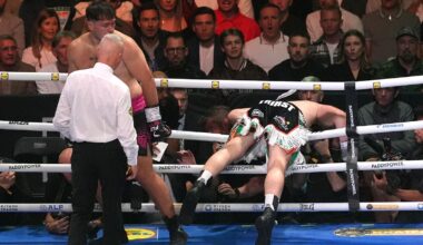 Carty falls through the ropes after receiving a blow to the back of the head from Allen