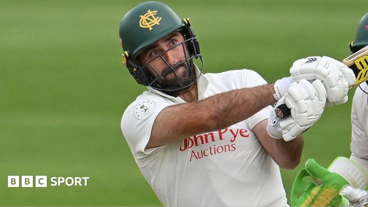 Brett Hutton, wearing a green Nottinghamshire helmet, plays a shot for Notts