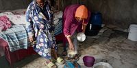 Gogo Toti watches as her granddaughter prepares a meal of noodles
