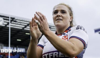 Amy Hardcastle in an England shirt applauding fans