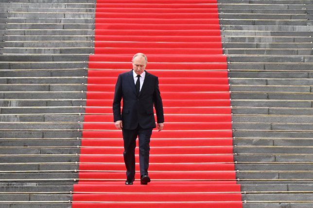 TOPSHOT - Russian President Vladimir Putin walks down the steps to address troops from the defence ministry, National Guard, FSB security service and interior ministry gathered on the Sobornaya (Cathedral) Square from the porch of the the Palace of the Facets on the grounds of the Kremlin in central Moscow on June 27, 2023. (Photo by Sergei GUNEYEV / SPUTNIK / AFP via Getty Images)