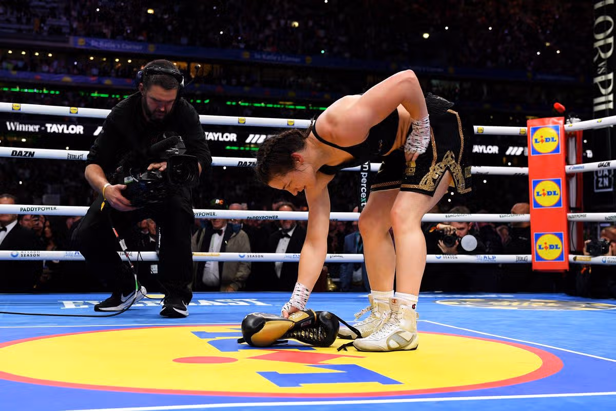 DUBLIN, IRELAND - SEPTEMBER 05: Katie Taylor places her gloves in the middle of the ring following victory in her final fight, the Women's IBF, IBO, WBC and WBO World Super Lightweight Titles' fight between Katie Taylor and Flora Pili on the Katie Taylor v Flora Pili: Once Upon A Time - Fight Night at Croke Park on September 05, 2026 in Dublin, Ireland. (Photo by Charles McQuillan/Getty Images)