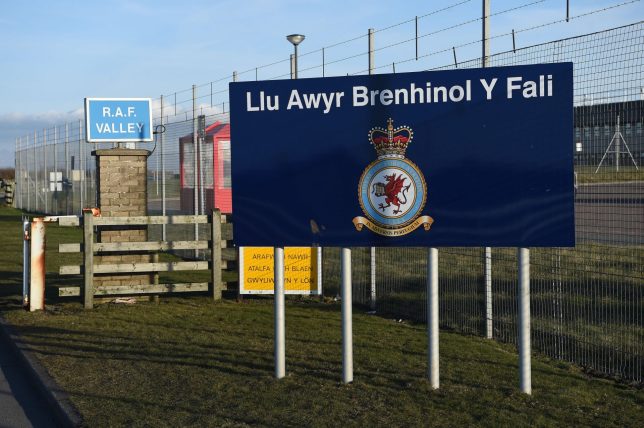 A sign is pictured at the entrance to the Royal Air Force (RAF) base Valley, at Anglesey Airport in Anglesey, north Wales on March 20, 2018. A British military jet used in the Red Arrows aerobatic display team crashed on Tuesday at a base in Wales, the Ministry of Defence said. Officials declined to give more details, but it was understood two people were on board when it crashed at the Valley Royal Air Force base. / AFP PHOTO / PAUL ELLIS (Photo credit should read PAUL ELLIS/AFP via Getty Images)