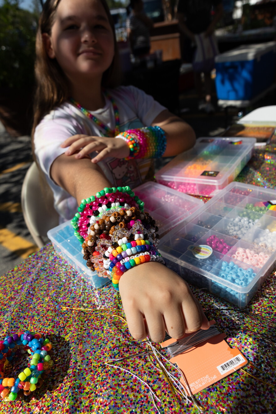 Violet Tweatt, 12, owner of Kandi Bracelets and More, shows off her wares at Eckert’s in Belleville on Saturday, Sept. 12, 2026, during the Kids Markets, an international nonprofit program that helps children practice entrepreneurial skills