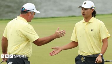 Ryan Fox of New Zealand and the International Team and Min Woo Lee of Australia give each other a high five