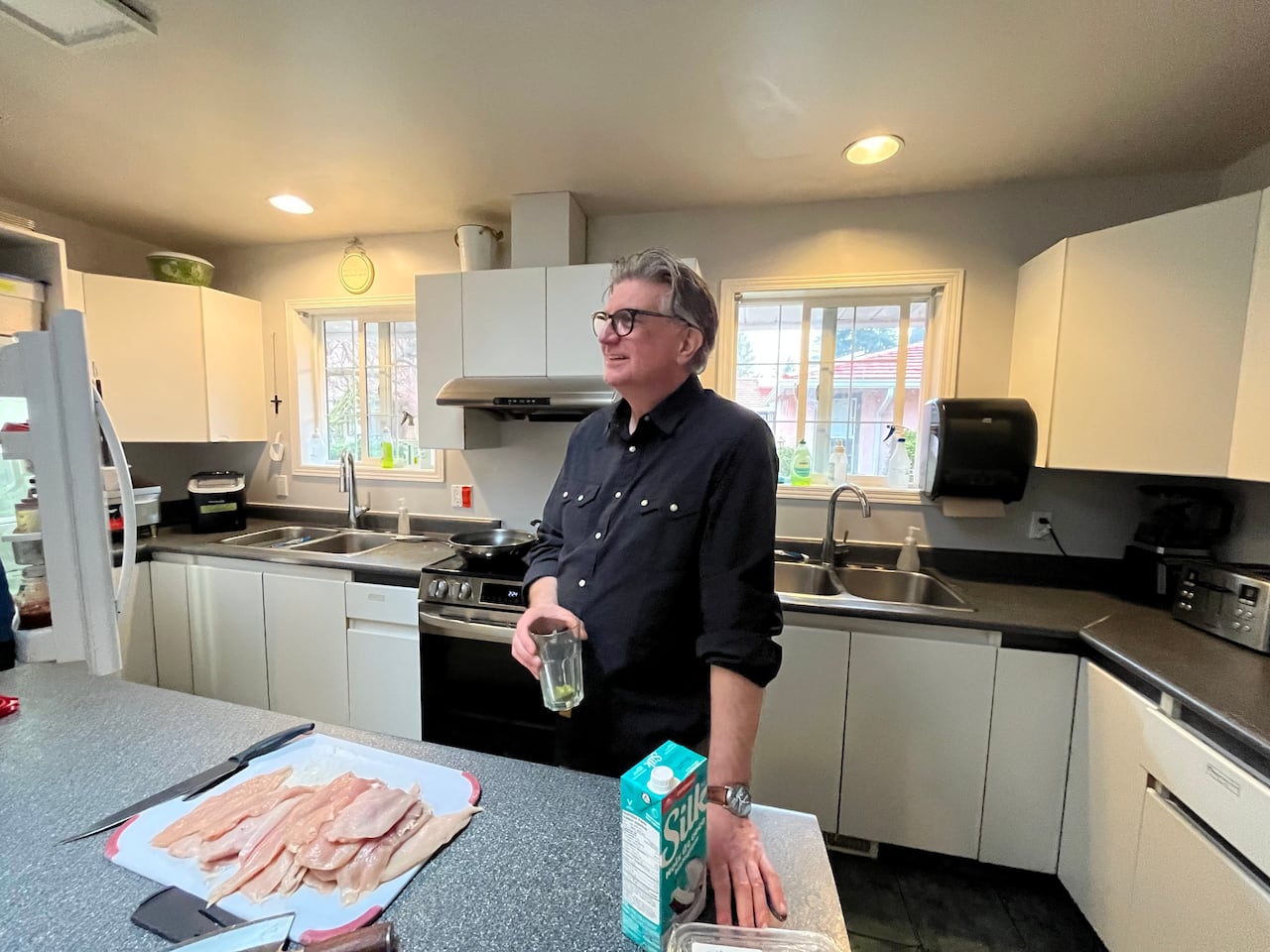 A man stands in a kitchen.