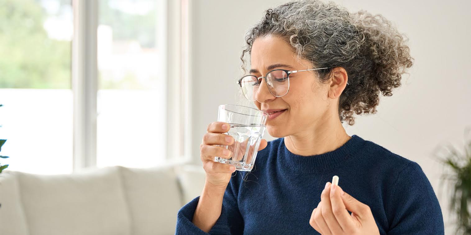 A woman taking a supplement