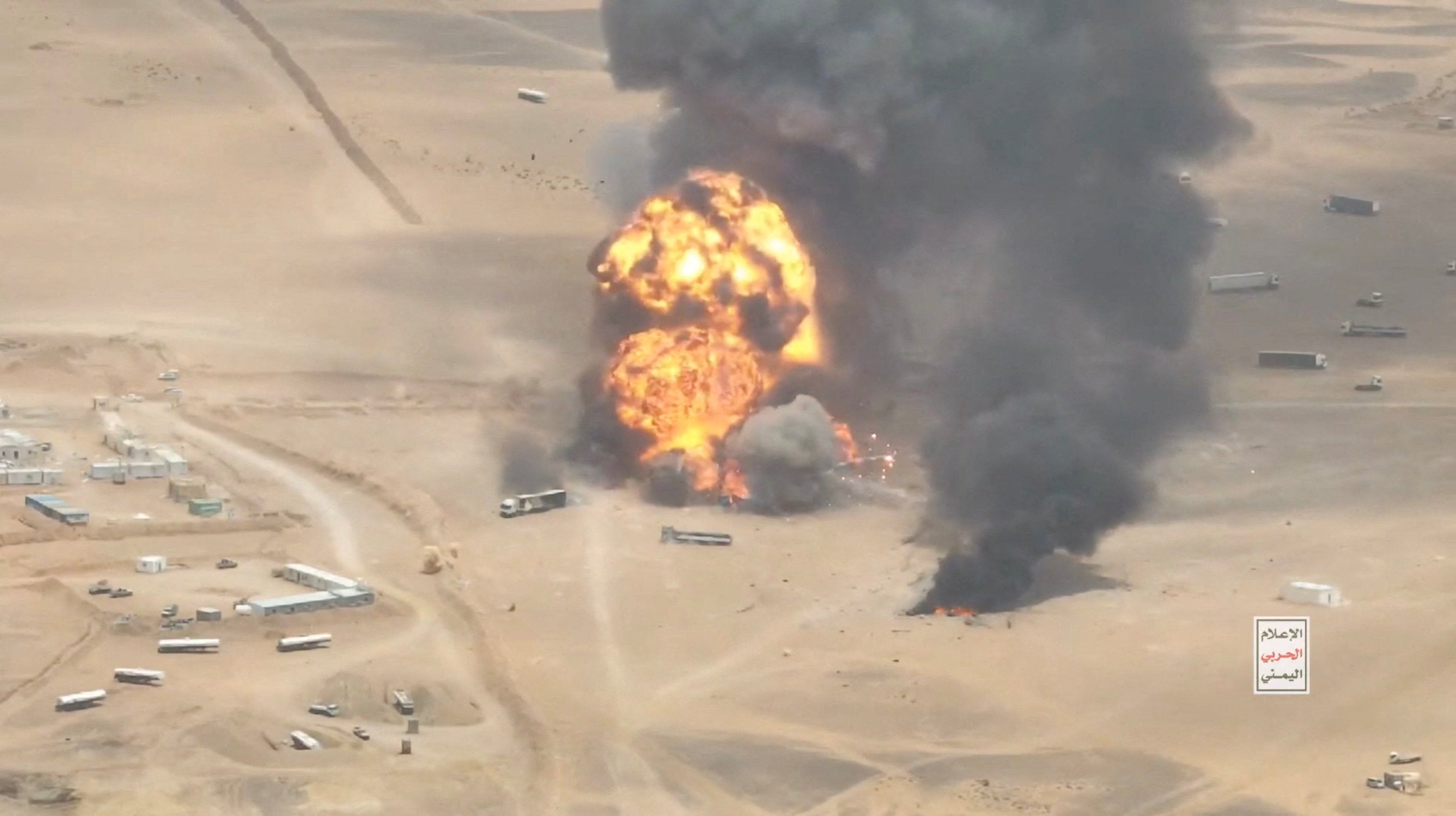 Trucks explode as they burn, during what the Houthis say was an attack targeting trucks coming from Saudi territory, at Al-Wadiah border crossing