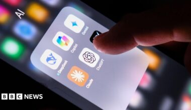 A hand on a phone displaying several AI apps including ChatGPT, Claude, Copilot, DeepSeek and Gemini