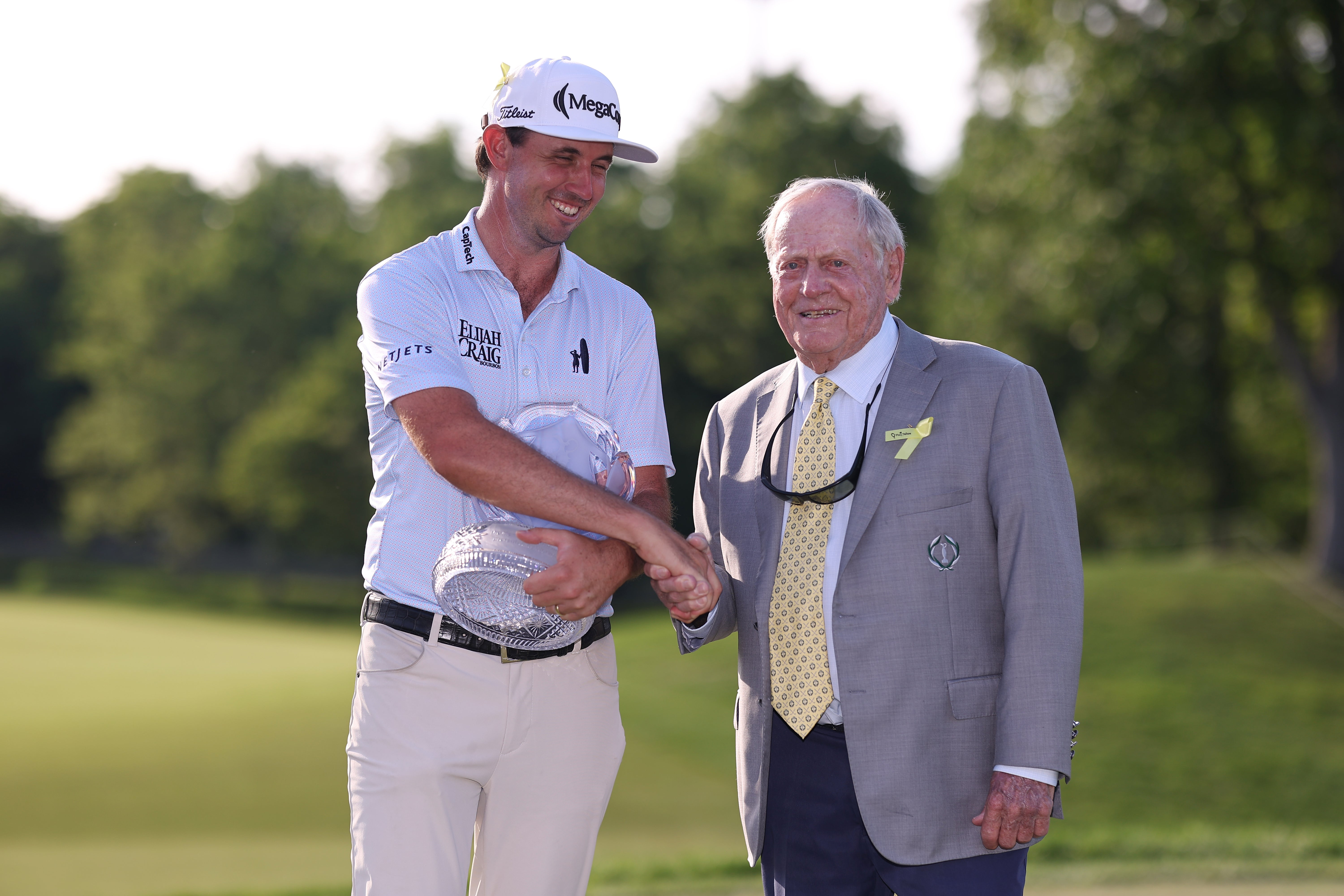 J.T. Poston of the United States shakes hands with Jack Nicklaus as he presents him the trophy during the final round of the the Memorial Tournament presented by Workday 2026 at Muirfield Village Golf Club on June 07, 2026