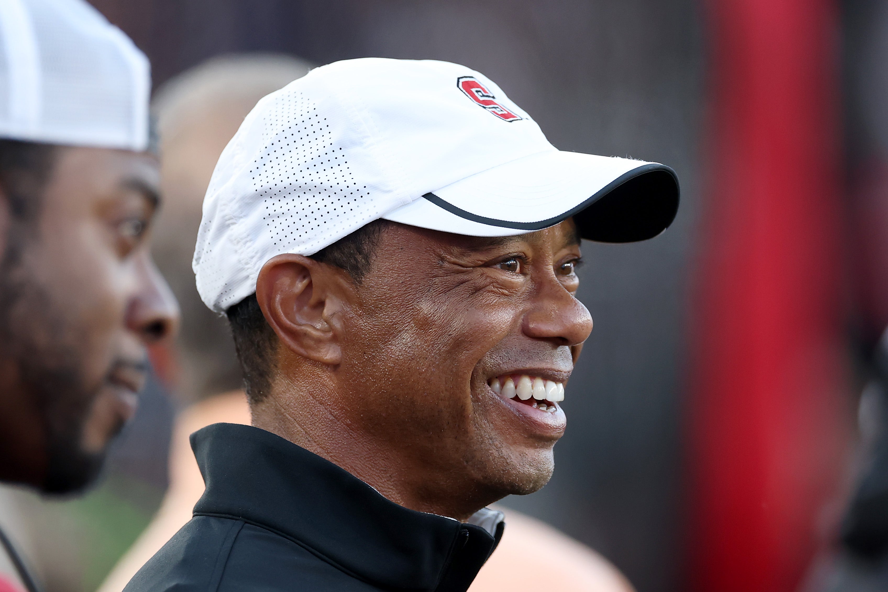 Professional golfer and Stanford Cardinal alumni Tiger Woods stands on the sidelines during the first half of the Stanford Cardinal game against the Miami (FL) Hurricanes at Stanford Stadium on September 04, 2026 in Stanford, California