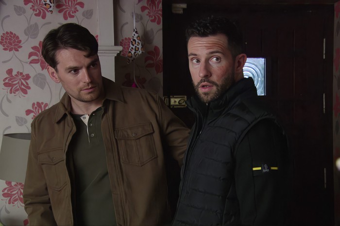 Ross and Mack look shifty in a scene from Emmerdale