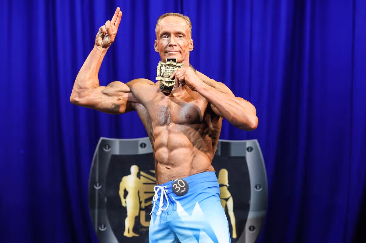 Phil Earley wins at the UK Ultimate Physiques Northern Championships in York on August 9th 2026, winning the title for a third time, which was noted by the announcer: “to win a Title is one thing, to win it three years in a row is amazing.”.