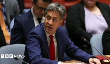 Britain's Foreign Secretary Ed Miliband attends a meeting of the United Nations Security Council, wearing a blue suit and red tie.
