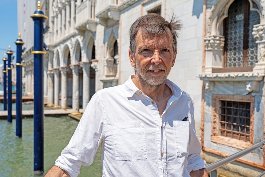 A man poses in Venice.