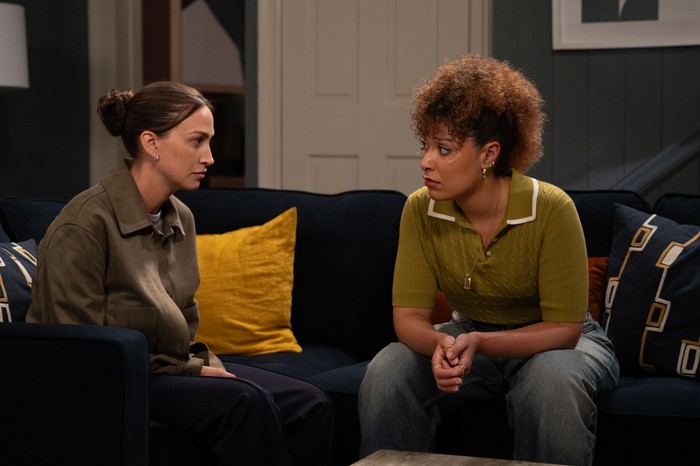 31_08_emm_ds_ramsden_serena_01 Thea Ramsden and Serena sit beside one another on a sofa in Emmerdale Farm in a scene from Emmerdale