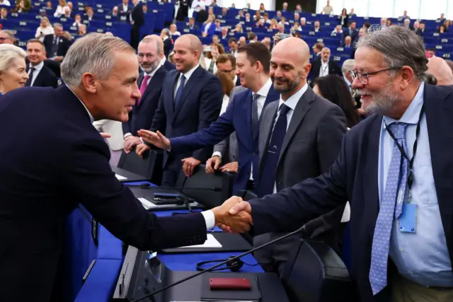 Canadian Prime Minister Mark Carney shakes hands with member of European Parliament