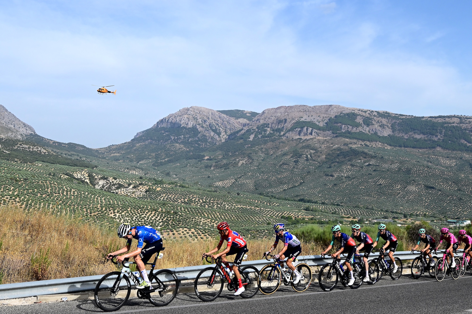 Enric Mas of Movistar Team in Red Leader Jersey leads Primoz Roglic of Red Bull - BORA - hansgrohe