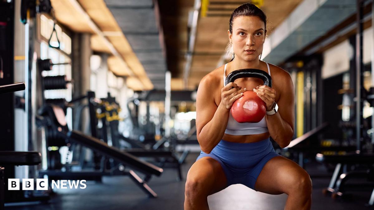 Sarah Mackay is pictured doing hip thrusts with a barbell in the gym.