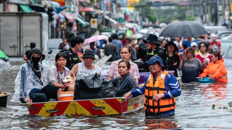 Bangkok residents navigate streets by boat as flood waters rise – video