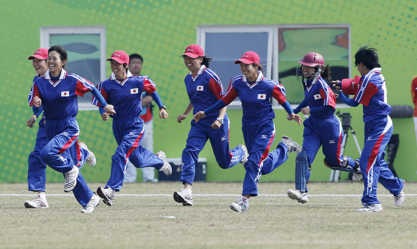 Japan's players run onto the field after beating China in the Asian Games Japan's players run onto the field after beating China in the Asian Games