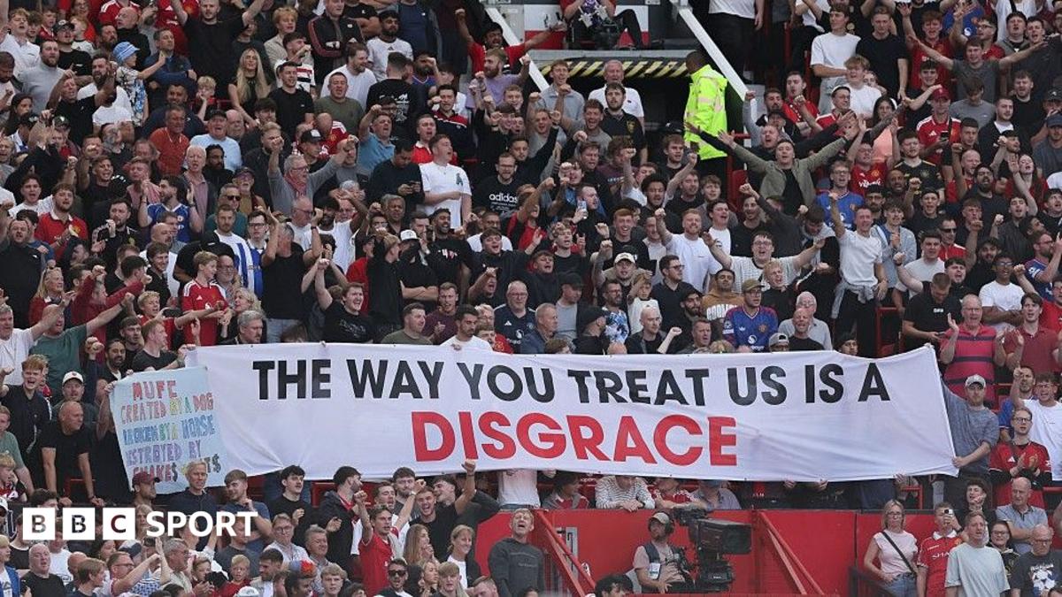 Manchester United fans unfurl a banner inside Old Trafford