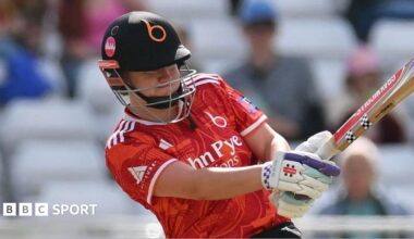 Kathryn Bryce holds the bat with two hands as she swings during a match for the Blaze.