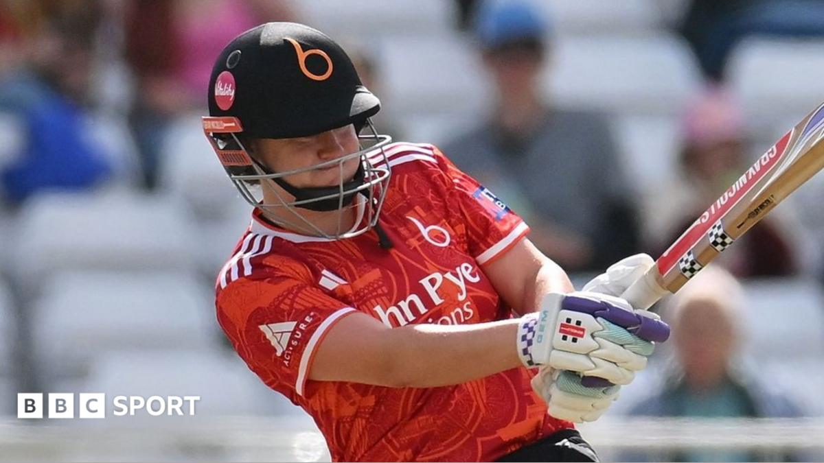 Kathryn Bryce holds the bat with two hands as she swings during a match for the Blaze.
