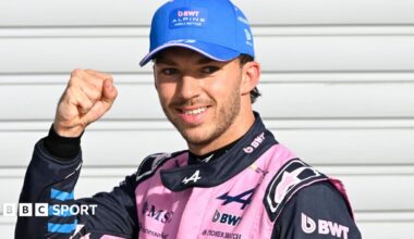 Alpine's Pierre Gasly poses with a picture of the '1' board after taking pole position at the Italian Grand Prix