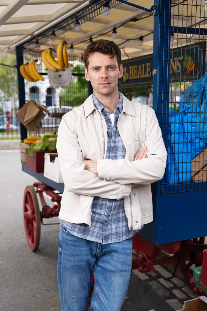 577298,TITLE:Eastenders Thomas Law as Peter Beale beside the fruit and veg stall in EastEnders