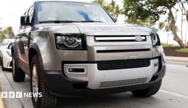 A silver Land Rover Defender parked on a road
