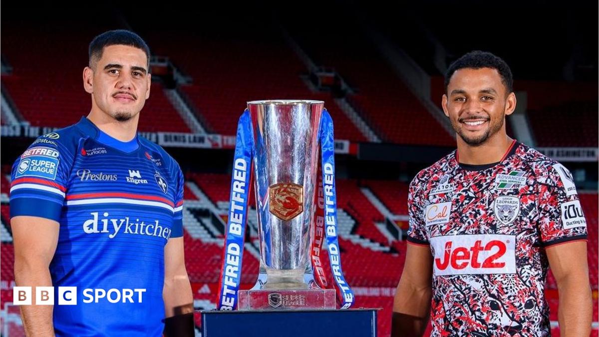 Wakefield boss Daryl Powell (left) and owner Matt Ellis (right) stand with their arms aloft in celebration
