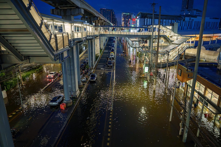 A flooded city at night, as seen from a high vantage point.