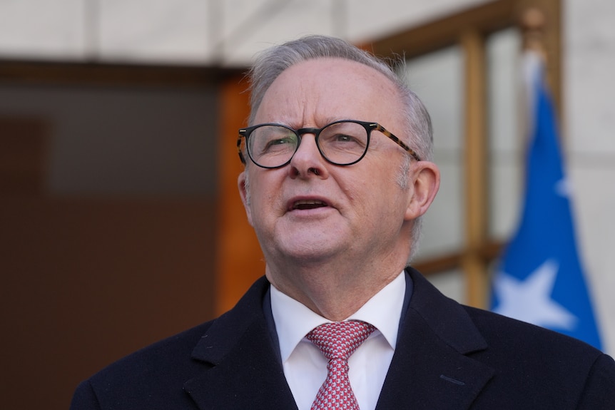 Prime minister Anthony Albanese looks slightly upwards and speaks.