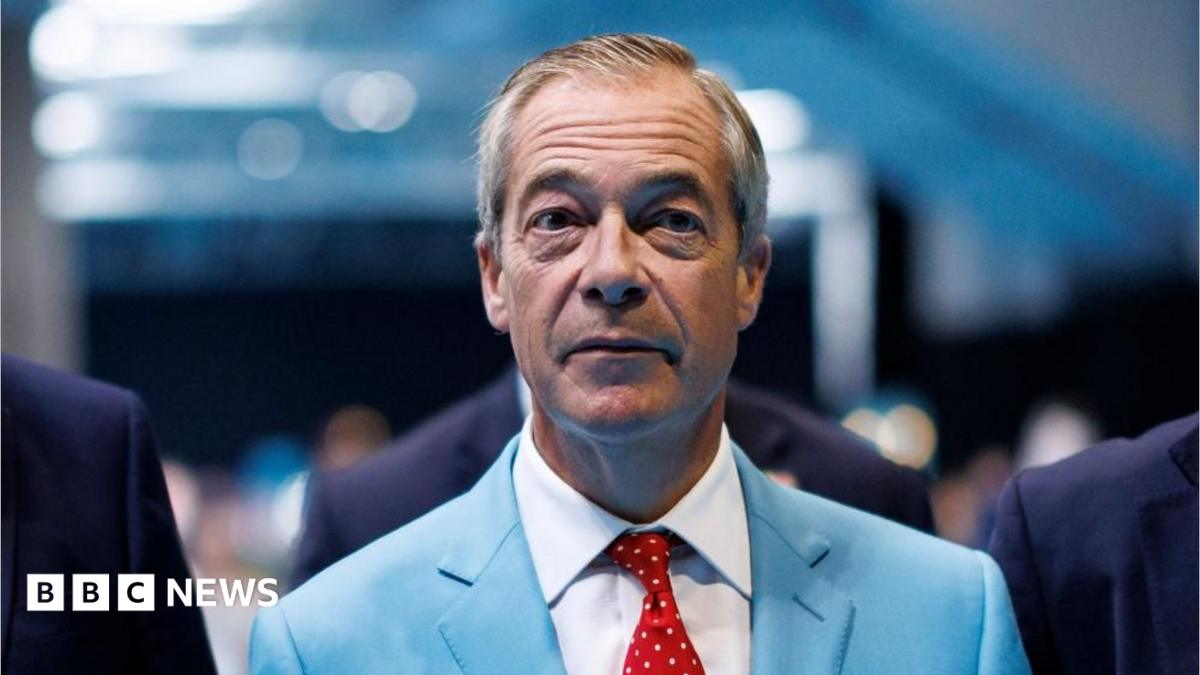 Reform UK leader Nigel Farage is wear a turquoise-coloured suit jacket, white shirt and a red tie with white dots.
