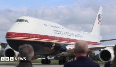 Air Force One on the tarmac in Ireland with blurred out people watching on.