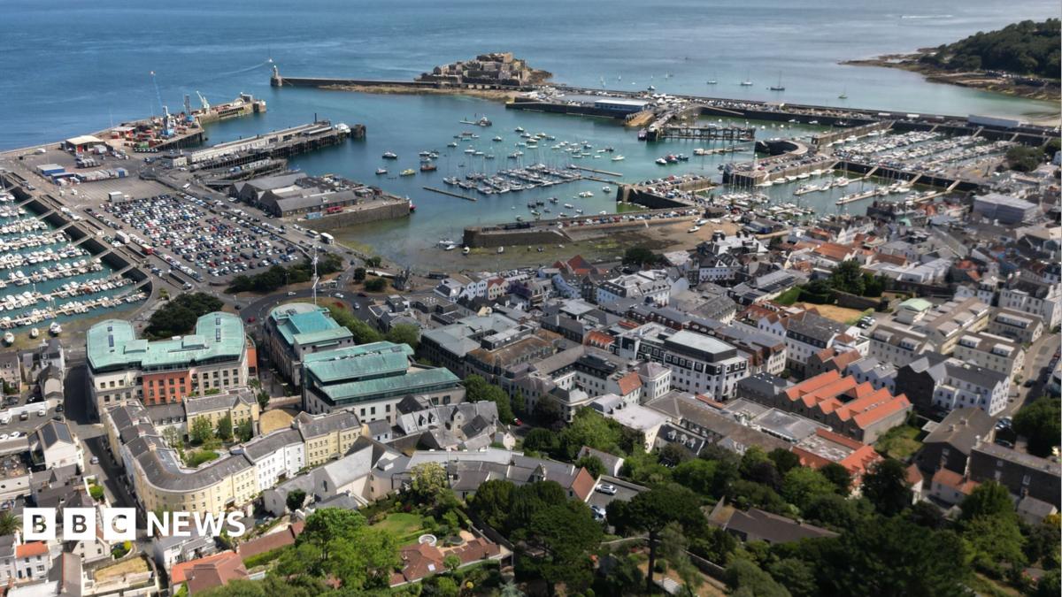 A drone picture of St Peter Port in Guernsey showing the islands busy capital with close buildings and the harbour in the background. Guernsey's castle cornet is in the background.