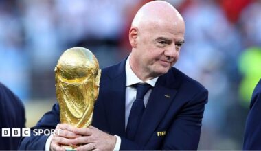 Gianni Infantino holding the World Cup trophy