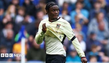 Abdul Fatawu holds his shirt while leaving the pitch.