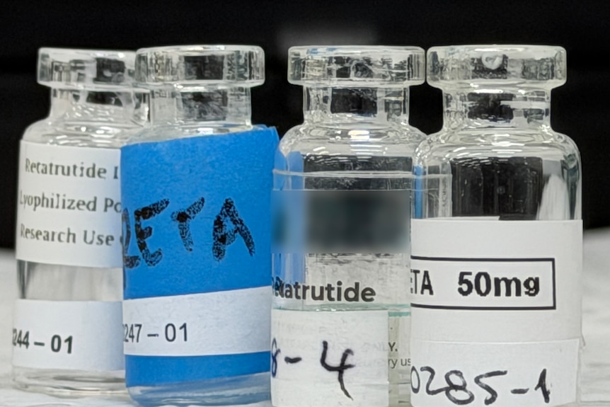Small glass bottles with liquid inside and labels on the outside