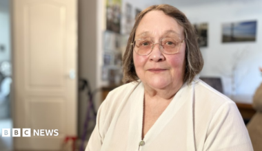 Leg ulcer patient from Swindon Deborah Williams  is wearing a cream blouse and has light brown hair and glasses