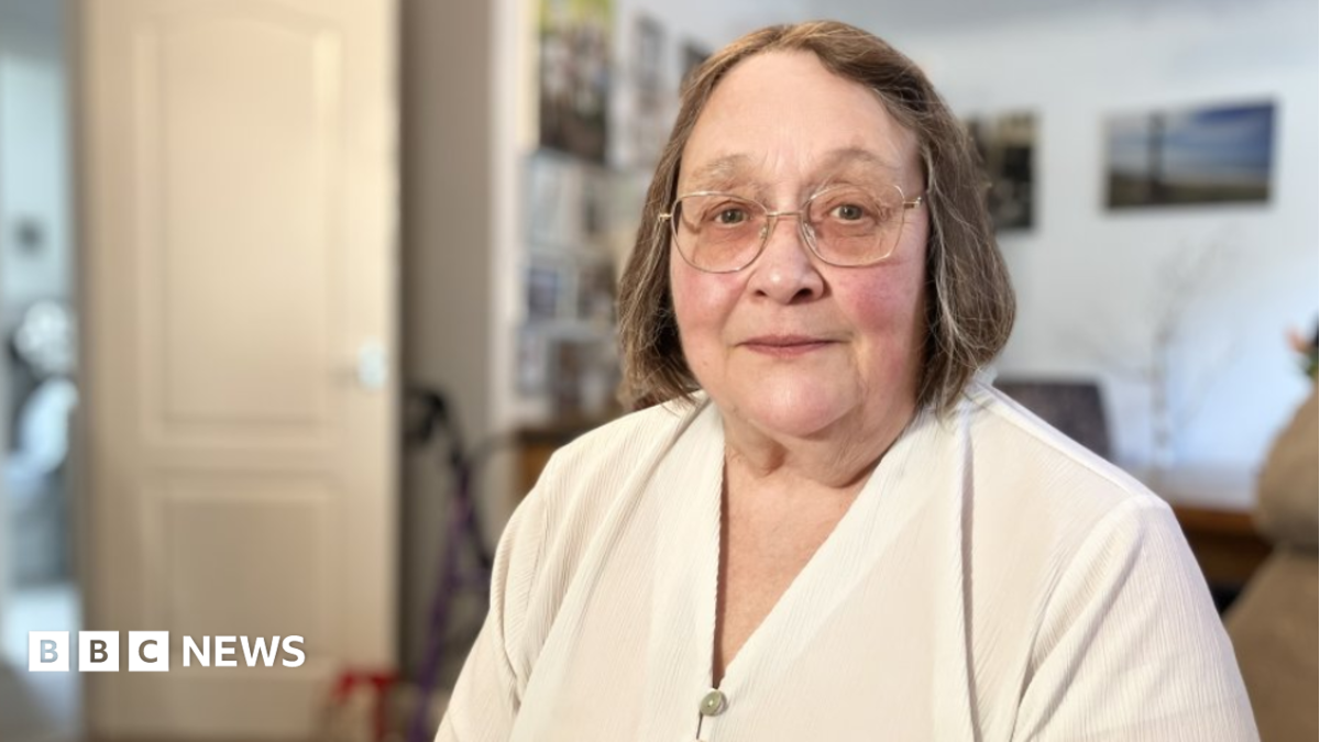 Leg ulcer patient from Swindon Deborah Williams  is wearing a cream blouse and has light brown hair and glasses