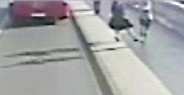 Police have released dramatic CCTV footage of the moment a jogger appeared to push a woman into the path of an oncoming bus in Putney. At about 07:40hrs on Friday, 5 May the 33-year-old victim was walking across Putney Bridge on the east side heading towards Putney Bridge Tube Station when a male jogger knocked her over into the road and into the path of an oncoming bus, which narrowly missed hitting her. The bus stopped and some passengers got off and rushed to the victim's aid. She received minor injuries from the incident.nnAbout 15 minutes later the jogger came back the other way across the bridge. The victim tried to speak to him but he did not acknowledge her and carried on jogging.nnThe jogger is described as a white man, aged early to mid 30s, with brown eyes and short brown hair. He was wearing a light grey t-shirt and dark blue shorts.nnOfficers are appealing for any witnesses to the incident or anyone who recognises the jogger in the CCTV to get in touch.