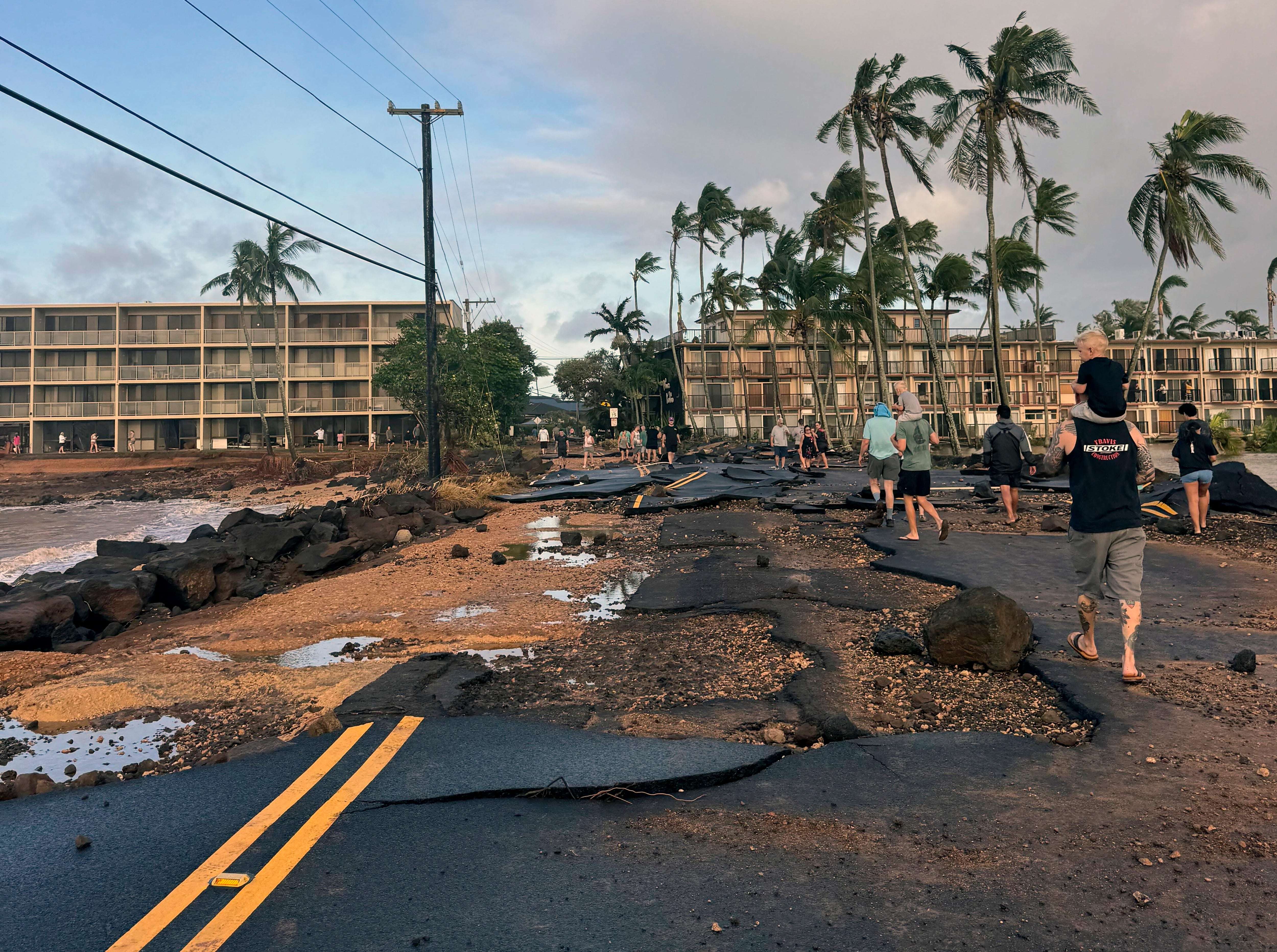People walk past damage caused by Hurricane Lowell on Tuesday, Sept. 8, 2026