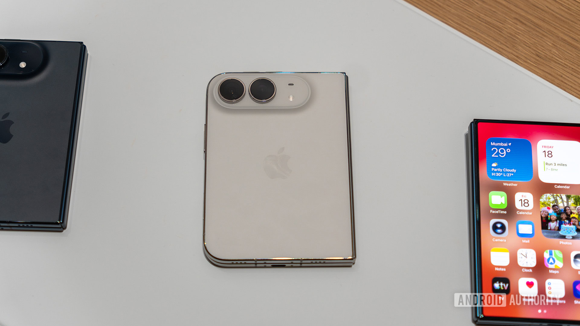 Apple iPhone Duo Hands On White color alonside black and cover display