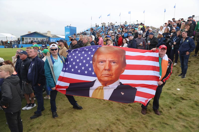 Nigel Johnston from Dublin (left) and Glenn Atkinson from Co Wicklow (right) holding a Trump flag during a visit by US president Donald Trump to the Irish Open. Photograph: Liam McBurney/PA Wire
