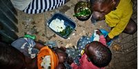 A mom shares spinach and pap with her three children. Hungry for Change series